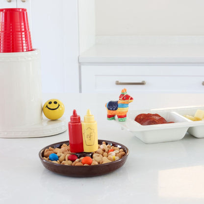 ketchup and mustard mini, happy face mini and pinata mini on a divided dish, dainty dish, utensil crock and solo cups