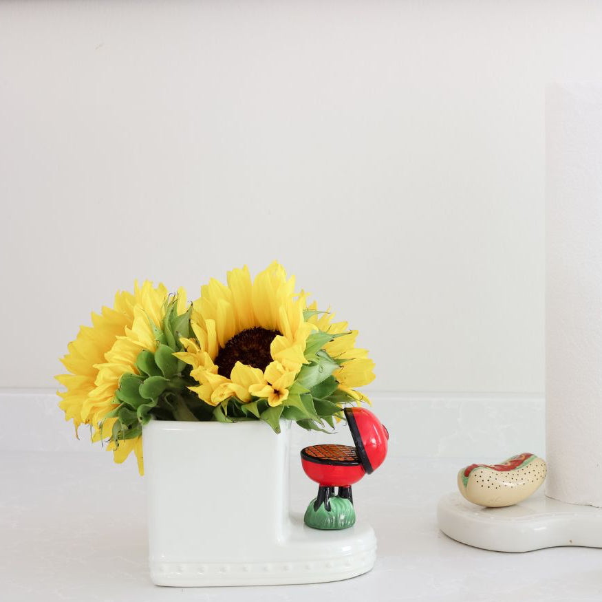 grill mini and mustard and ketchup and hot dog with sunflowers in a cutie container and melamine paper towel holder with salt and pepper shakers