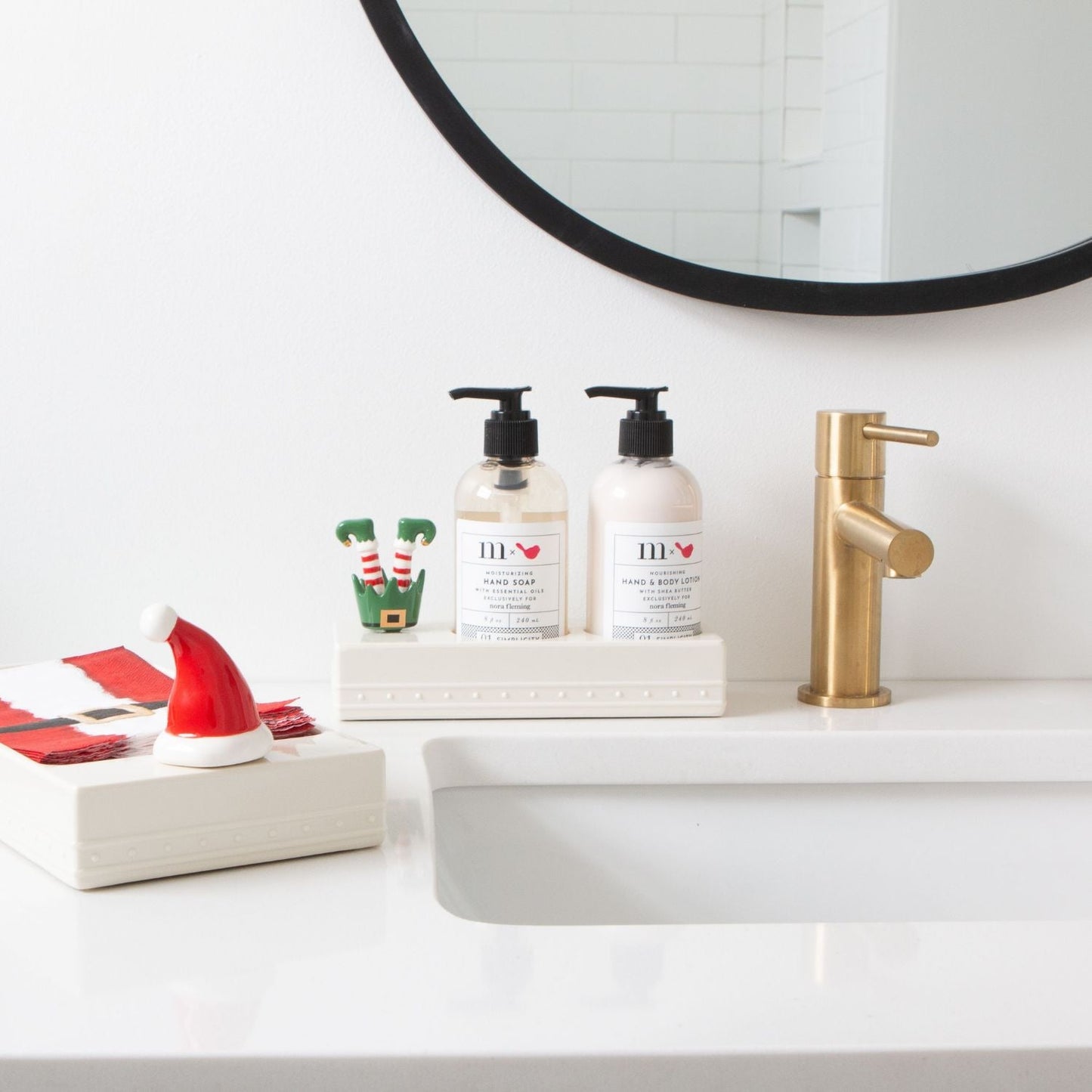 Santa hat mini with elf mini on soap and lotion dispenser and napkin holder