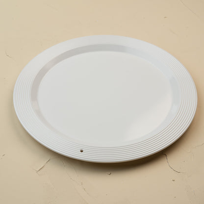 White melamine round platter on a beige background